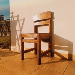 Empty chairs and table against wall at home