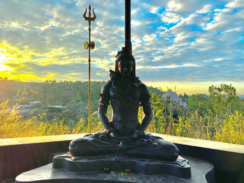 Statue against sky during sunset