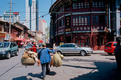 Cars on street against buildings in city