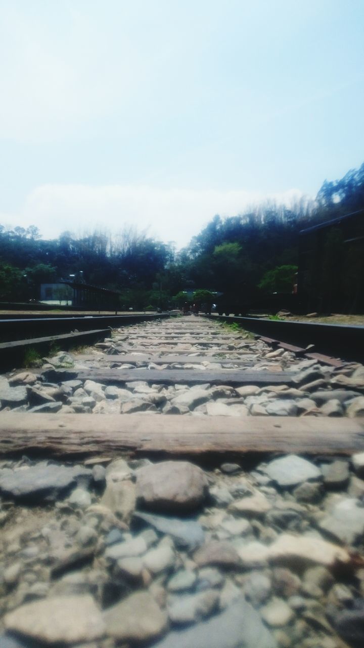 mountain, sky, railroad track, the way forward, tree, built structure, surface level, clear sky, transportation, connection, railing, architecture, rail transportation, diminishing perspective, bridge - man made structure, day, nature, outdoors, tranquility, no people