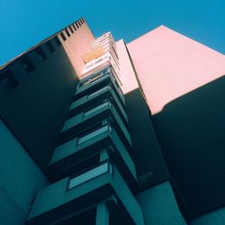 Low angle view of office building against blue sky