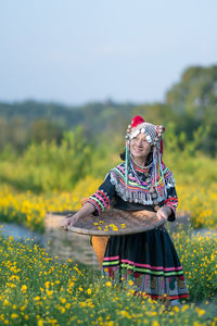 Low angle view of woman standing on field