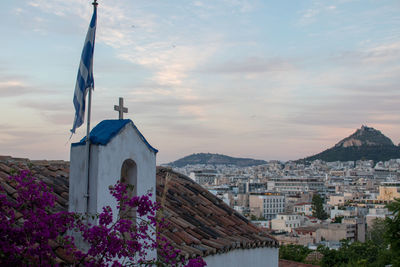 Panoramic view of buildings and city against sky at sunset