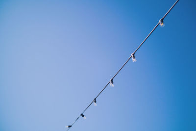 Clear light bulbs against blue sky