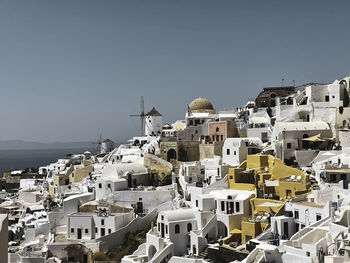 High angle view of townscape by sea against clear sky