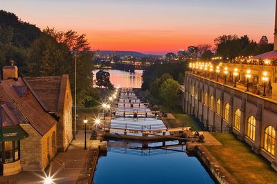 High angle view of illuminated buildings against sky during sunset