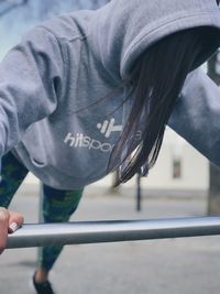 Woman exercising on railing