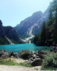 Scenic view of river in mountains against clear sky