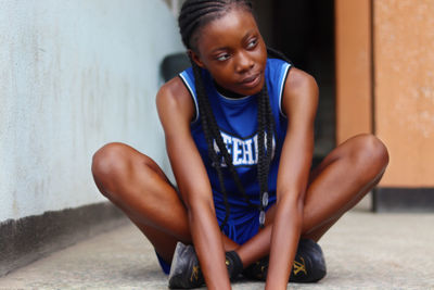 Portrait of young woman exercising at gym