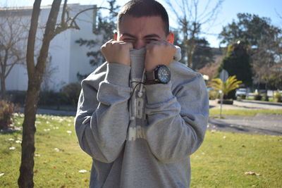 Portrait of young man standing outdoors