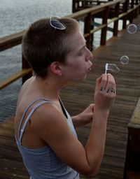 High angle view of woman blowing bubbles