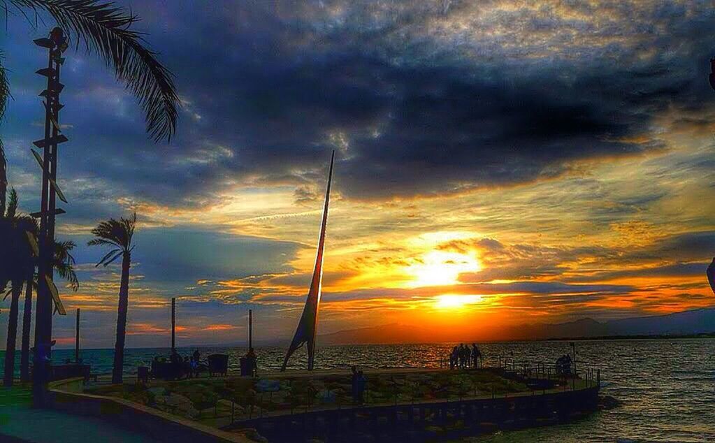 sunset, sky, sea, water, scenics, tranquility, beauty in nature, horizon over water, tranquil scene, cloud - sky, orange color, nature, idyllic, silhouette, cloudy, beach, pier, dramatic sky, cloud, sun