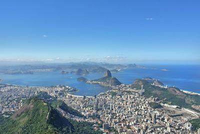 High angle view of townscape by sea against sky