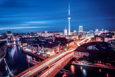 Aerial view of illuminated city buildings at night
