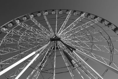 Low angle view of ferris wheel against sky