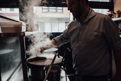 Male chef preparing crepes in restaurant kitchen