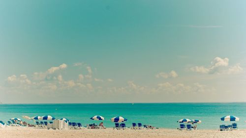 Scenic view of beach against blue sky