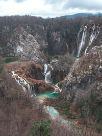 Scenic view of waterfall against sky