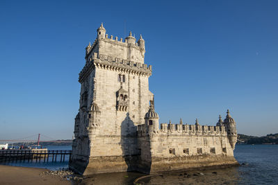 Low angle view of historic building against clear blue sky