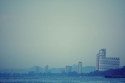 Modern buildings in city against clear sky