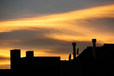 Low angle view of wooden post against sky during sunset