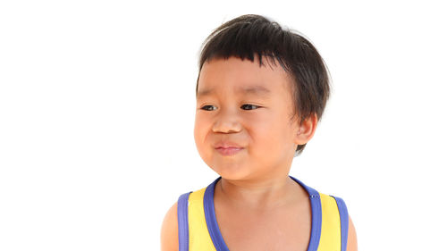 Portrait of cute boy against white background