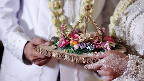 Midsection of woman holding flower bouquet