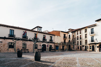 Buildings in town against sky