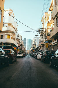 View of city street and buildings against sky