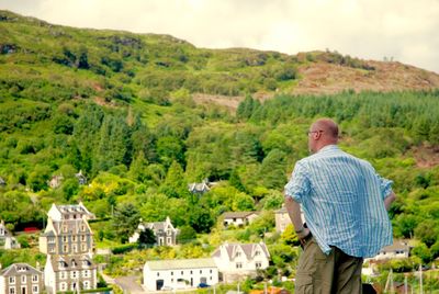 Man standing on mountain against sky