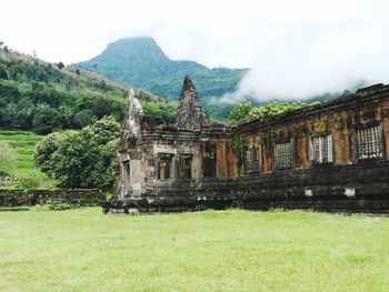 Built structure on landscape against the sky