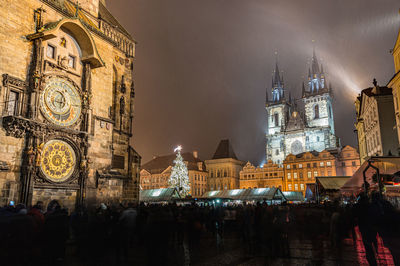 Group of people in front of buildings at night