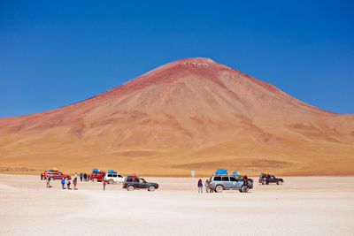 Scenic view of desert against clear blue sky