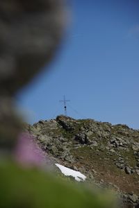 Low angle view of rocks on mountain against sky