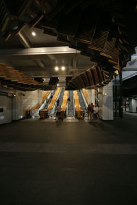 People walking in illuminated building