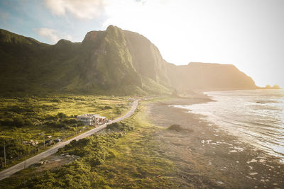 Scenic view of sea and mountains against sky