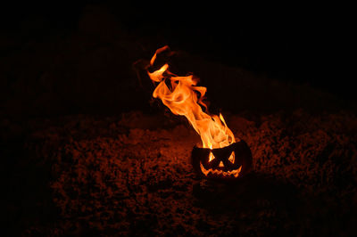 Close-up of bonfire in pumpkin during halloween night