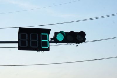 Low angle view of road signal against sky
