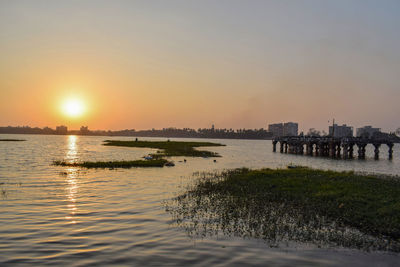 Scenic view of river against sky during sunset