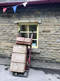 View of abandoned house against brick wall