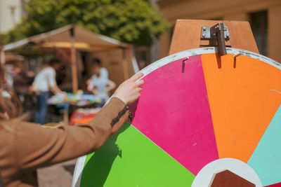 Close-up of hand holding multi colored umbrella