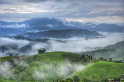 Scenic view of mountains against cloudy sky