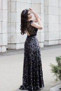 Beautiful woman looking away and posing while standing on road