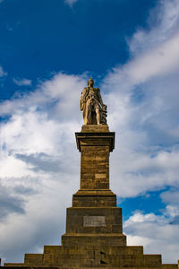 Low angle view of statue against sky