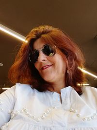 Low angle view of mid adult woman wearing sunglasses