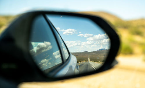 Reflection of road on side-view mirror