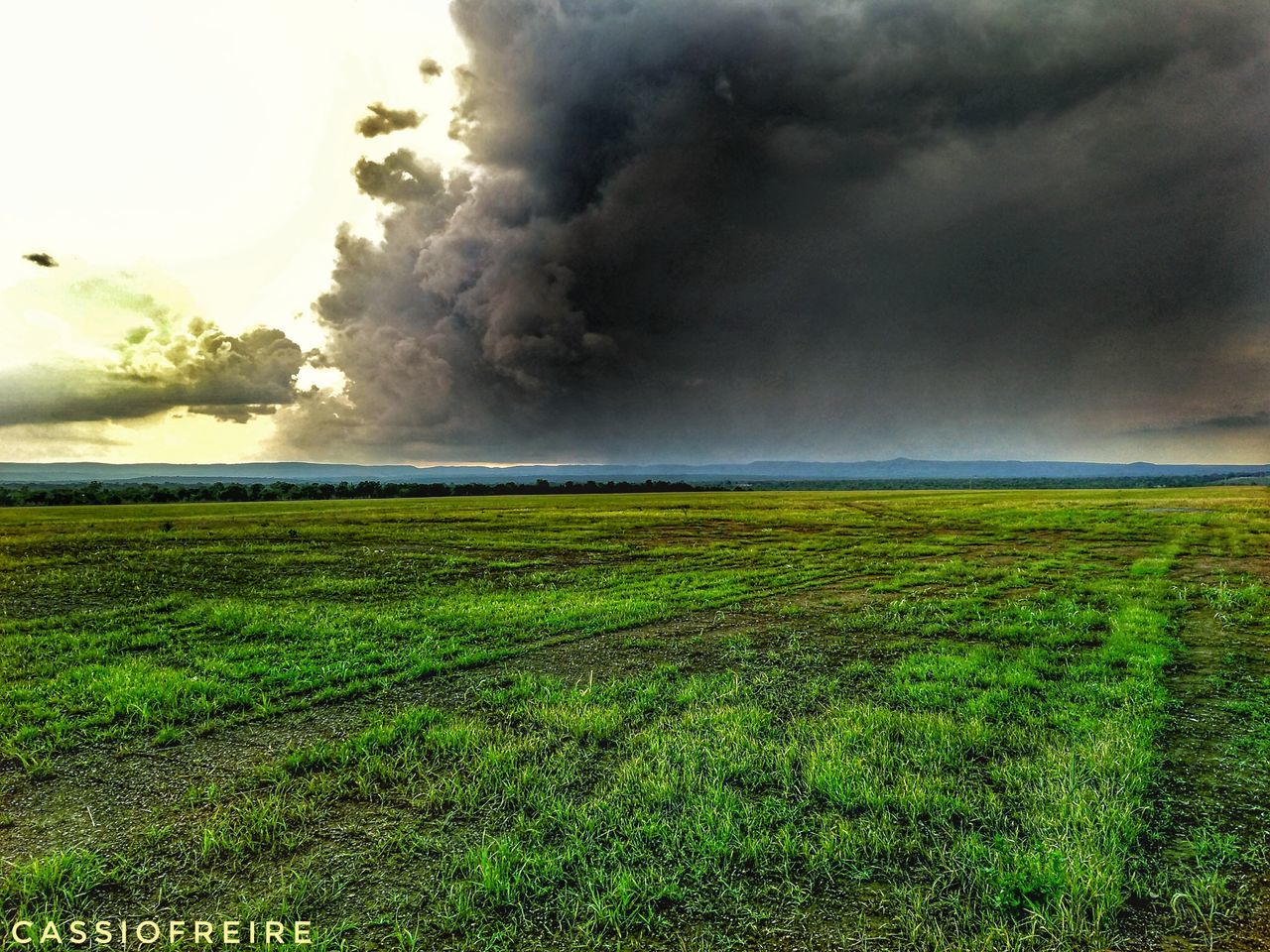 field, grass, nature, landscape, beauty in nature, scenics, sky, no people, tranquil scene, tranquility, cloud - sky, outdoors, green color, power in nature, day, storm cloud, rural scene, tornado