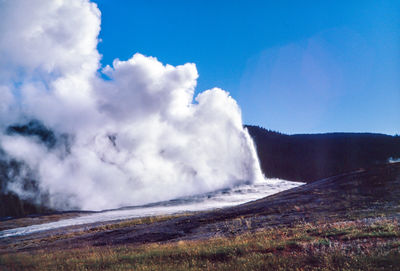 Scenic view of waterfall against sky