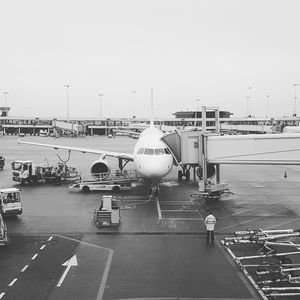 Airplane on airport runway against clear sky