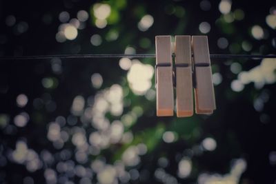 Close-up of illuminated lanterns hanging on clothesline